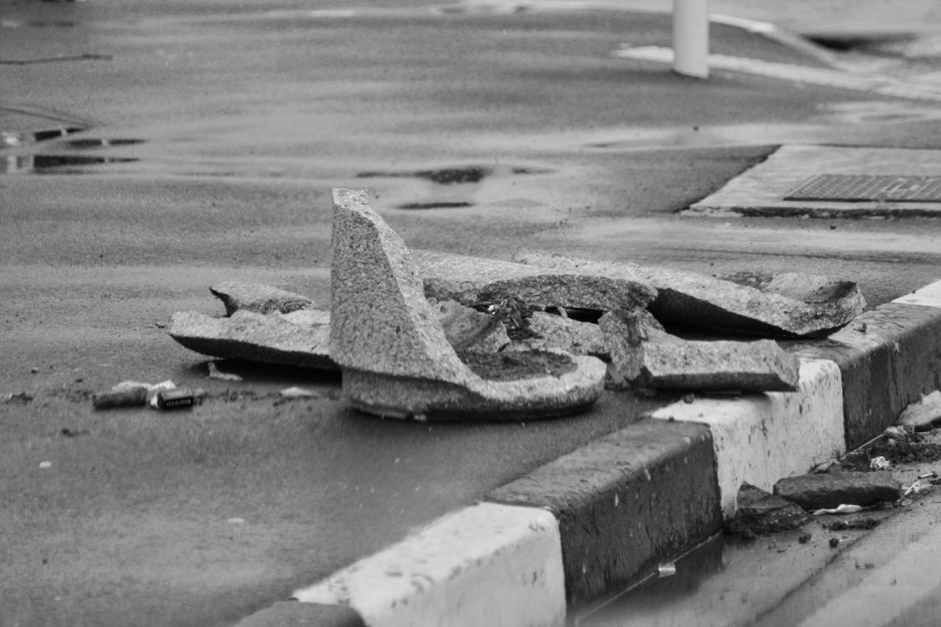 a black and white photo of a broken stop sign 3AzWmy7