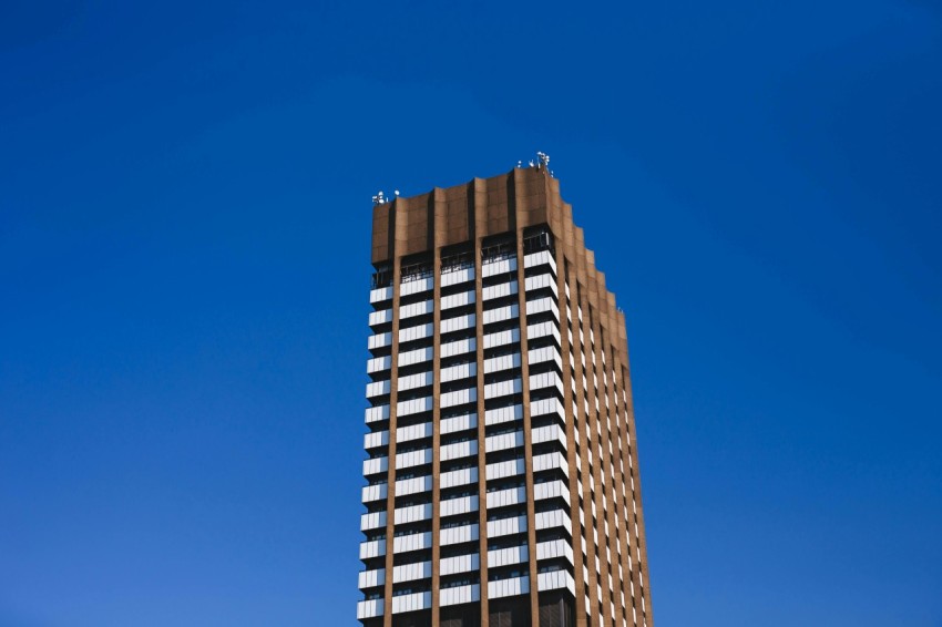 brown concrete building under blue sky during daytime Qy Mosd