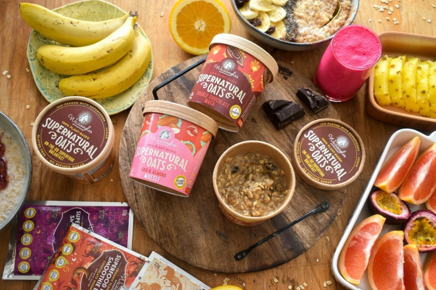 a wooden table topped with bowls of fruit and ice cream