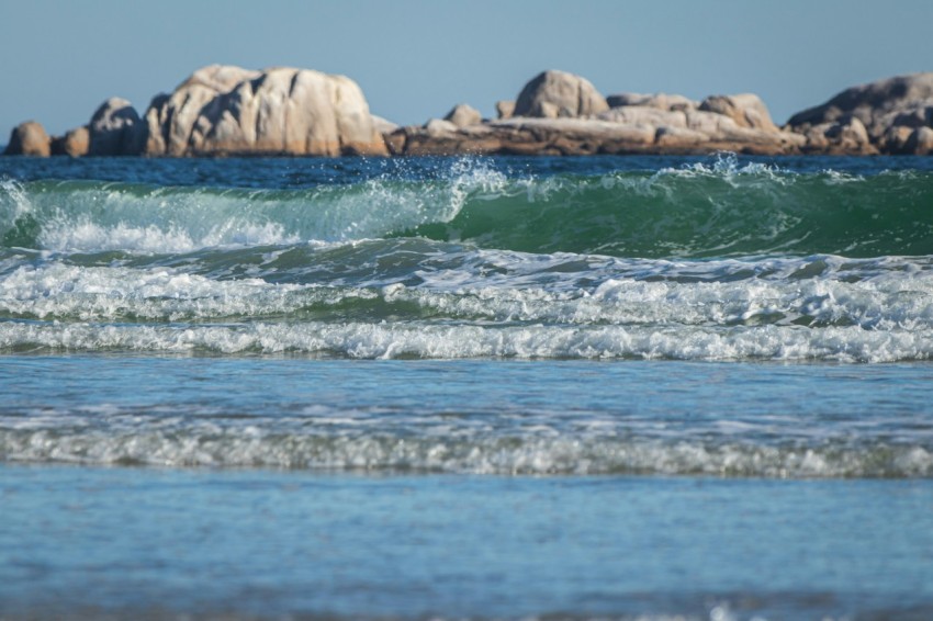 a man riding a surfboard on top of a wave in the ocean