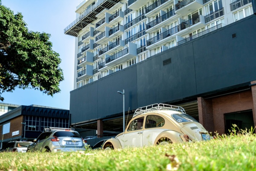 a car parked in front of a tall building