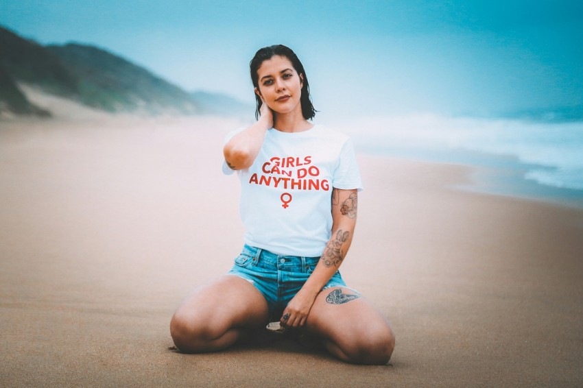 woman wearing white crew neck shirt near sea