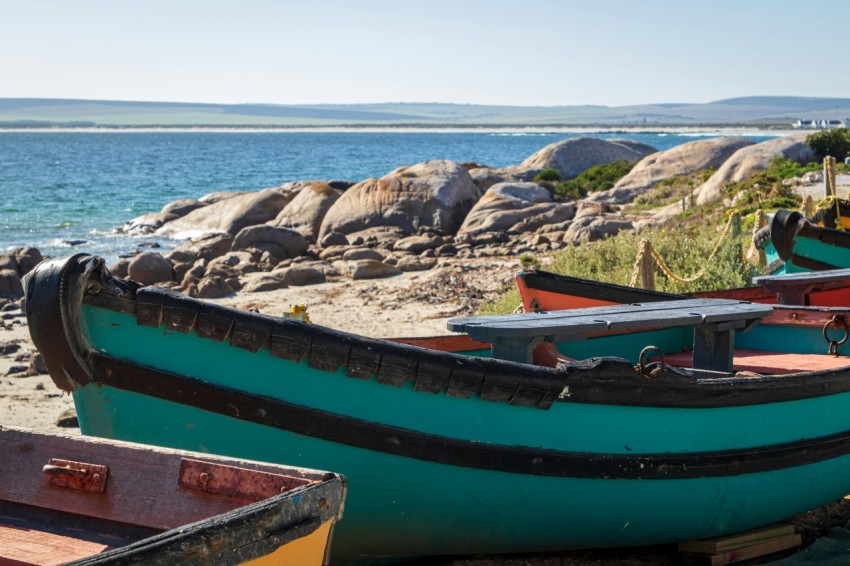 a group of boats sitting on top of a beach