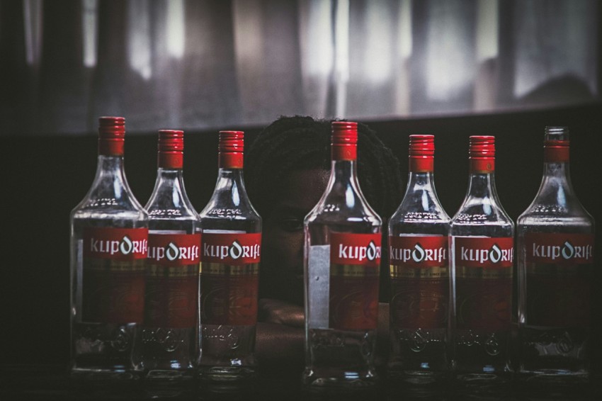 a row of bottles of liquor sitting on top of a table