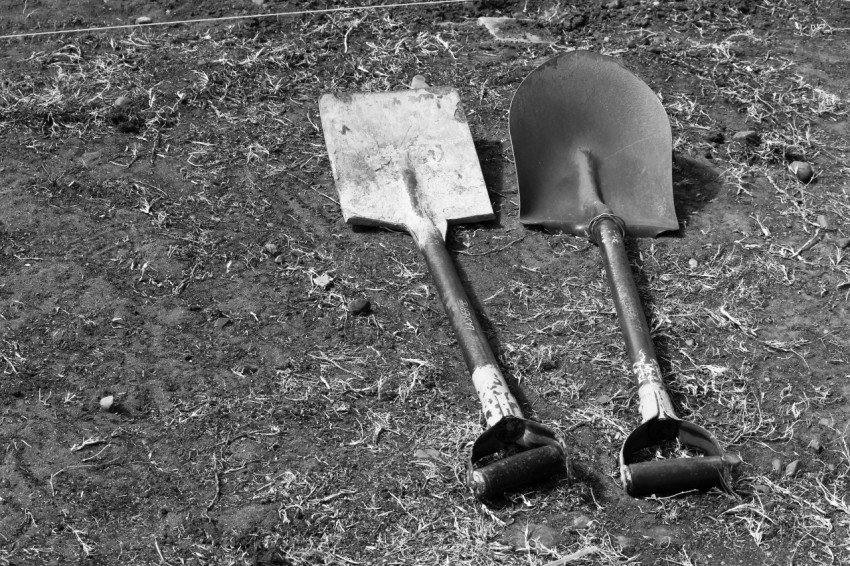 a pair of shovels laying on the ground