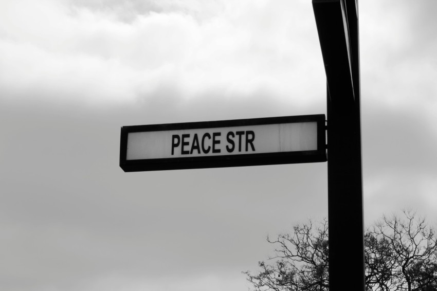 a black and white photo of a street sign