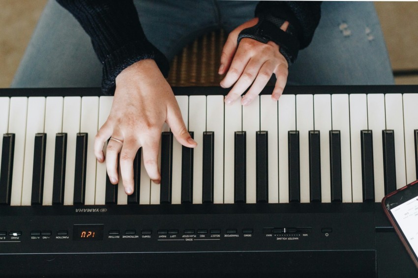 person playing electronic keyboard pSx