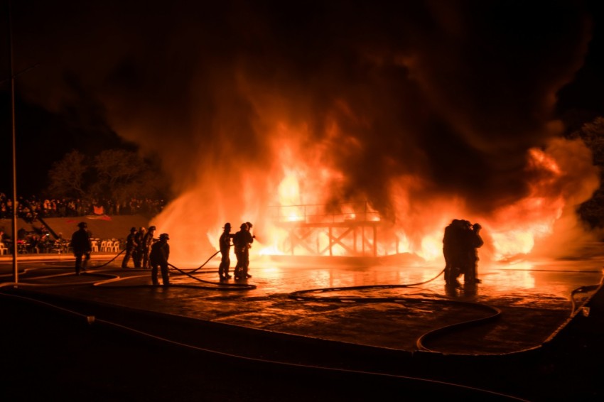 a group of people standing next to a fire