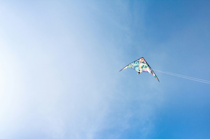 a kite flying high in the blue sky