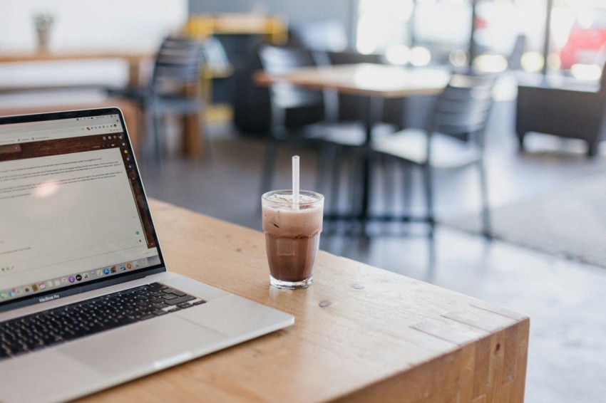 macbook pro on brown wooden table