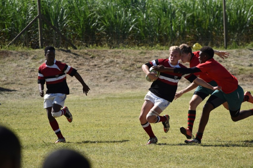 group of men playing soccer on green grass field during daytime 6N8VK