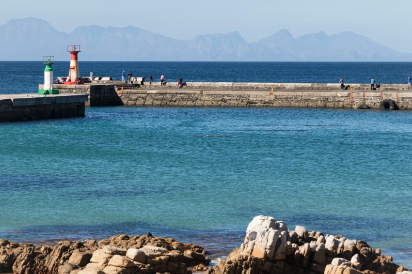 a body of water with a light house in the distance