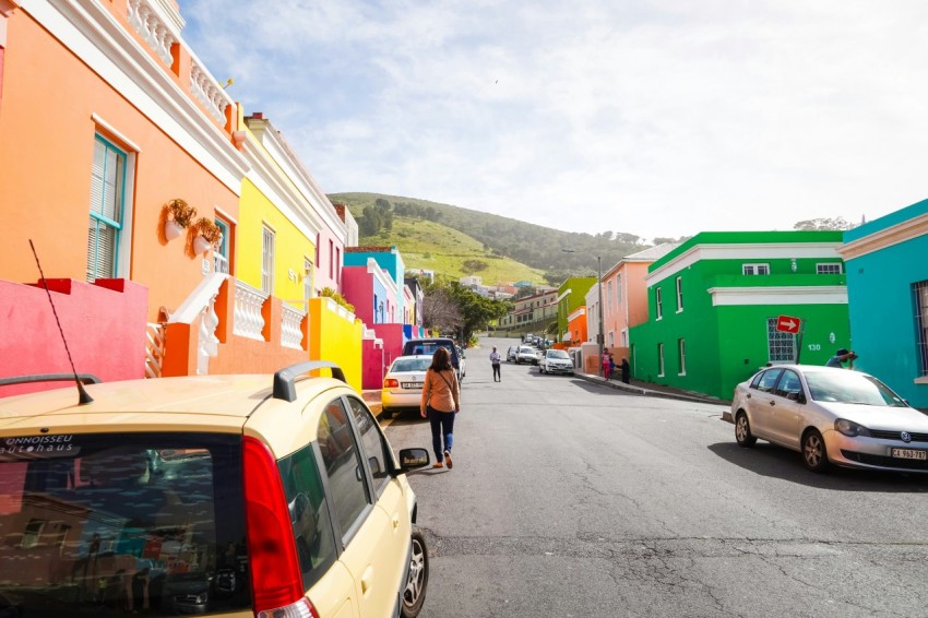 cars parked beside road near houses during daytime