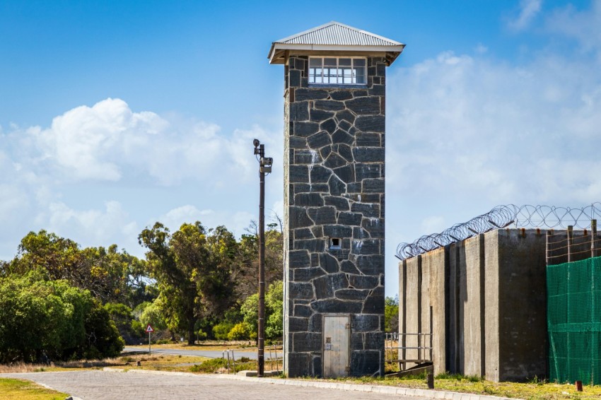 tower beside fence and road during day