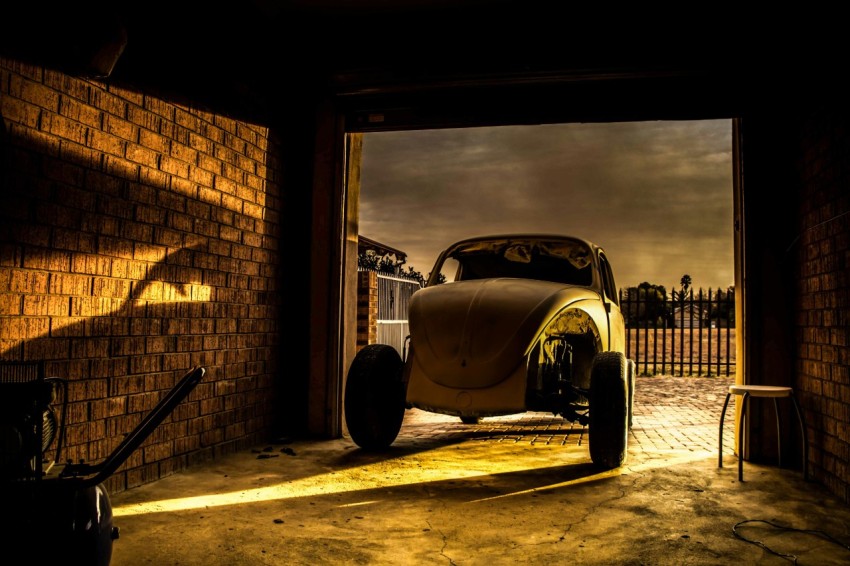 gray volkswagen beetle in garage