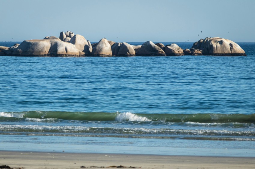 a group of large rocks sitting on top of a beach