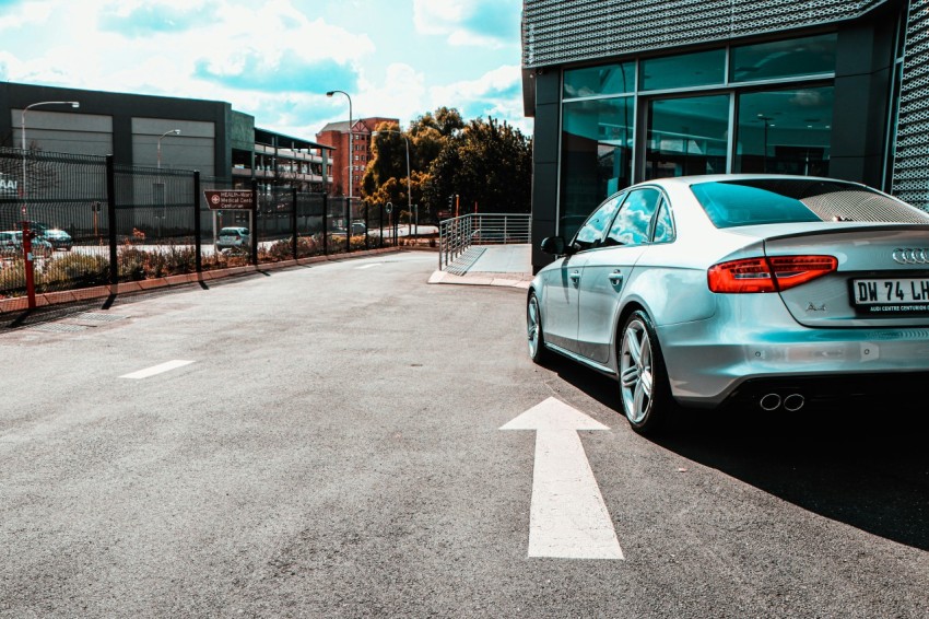 white sedan parked near building during daytime