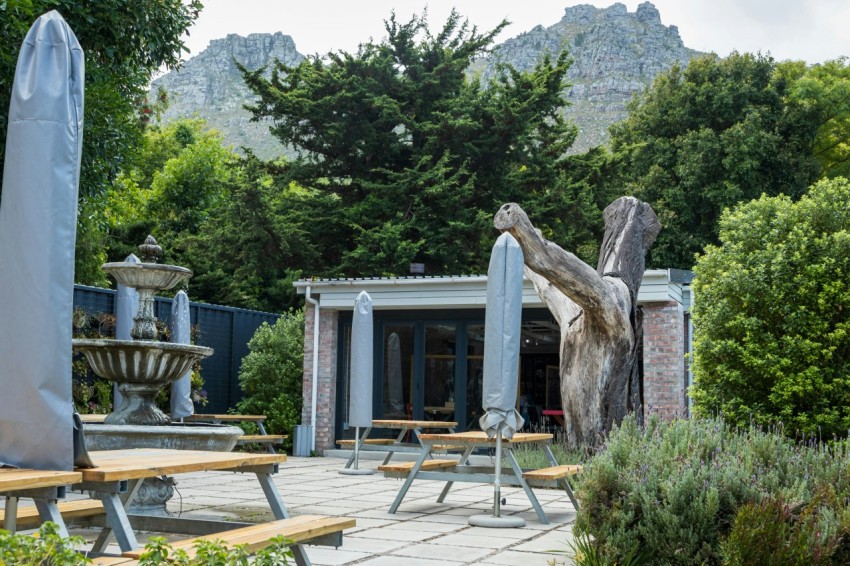 a building with a fountain and trees in the back