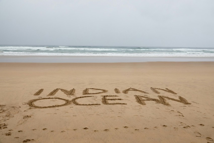 indian ocean word on brown sand beach