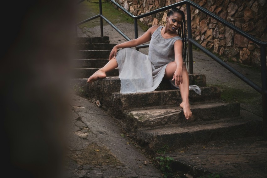 woman in white dress sitting on stairs