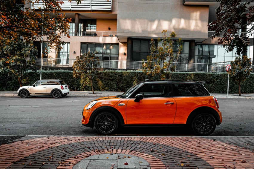 orange car parked on the side of the road