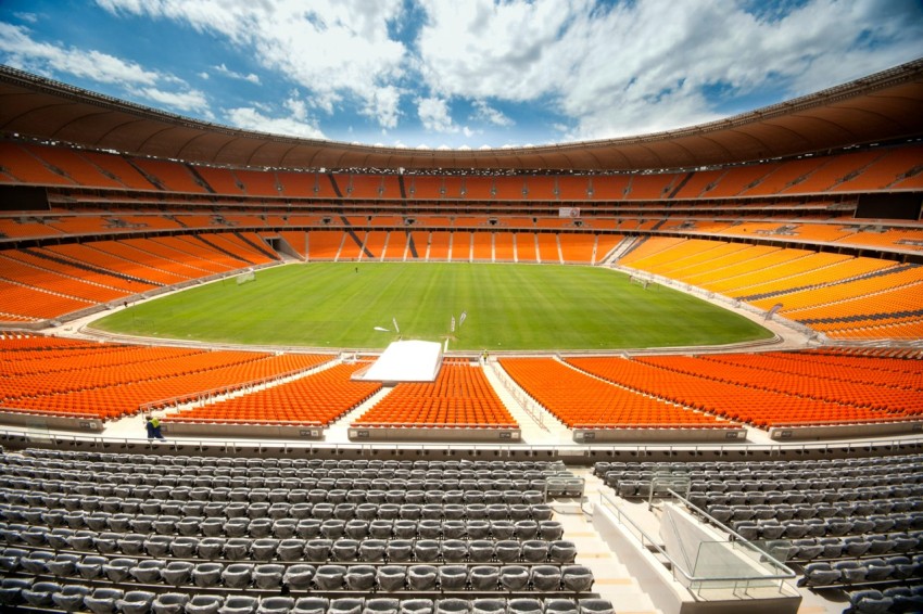 brown and green football field under blue sky during daytime YRo