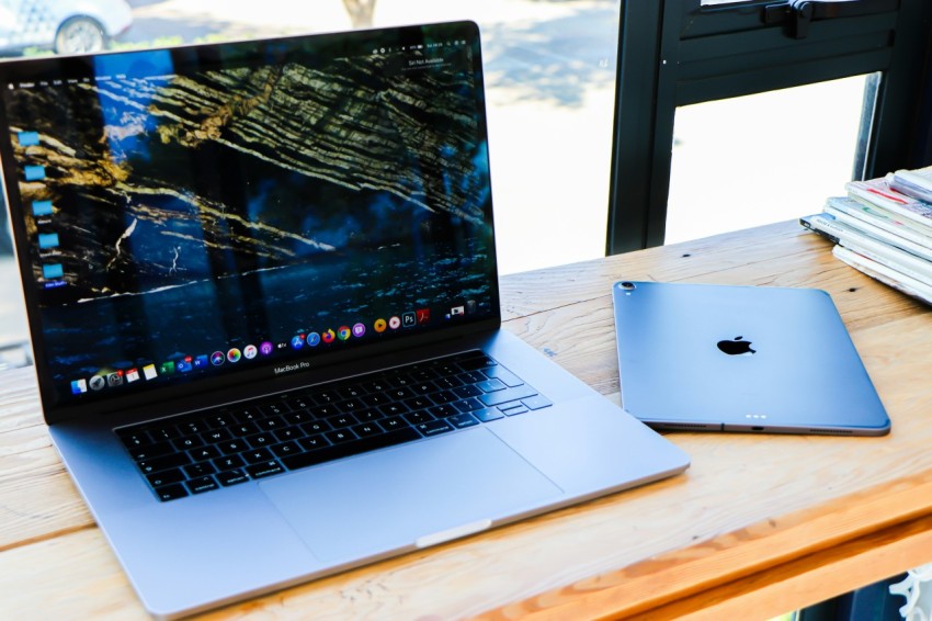 macbook pro on brown wooden table