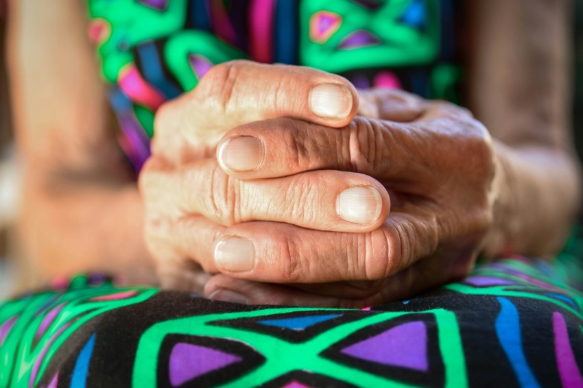 a close up of a person holding their hands together QjG2jg