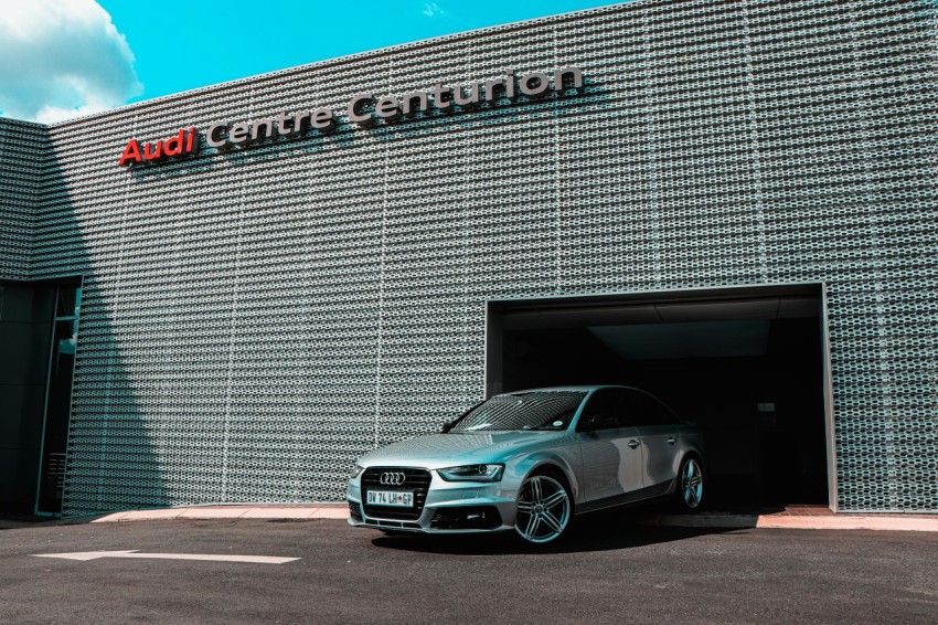 silver mercedes benz coupe parked beside gray concrete wall