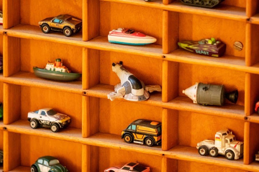 a shelf filled with lots of toy cars