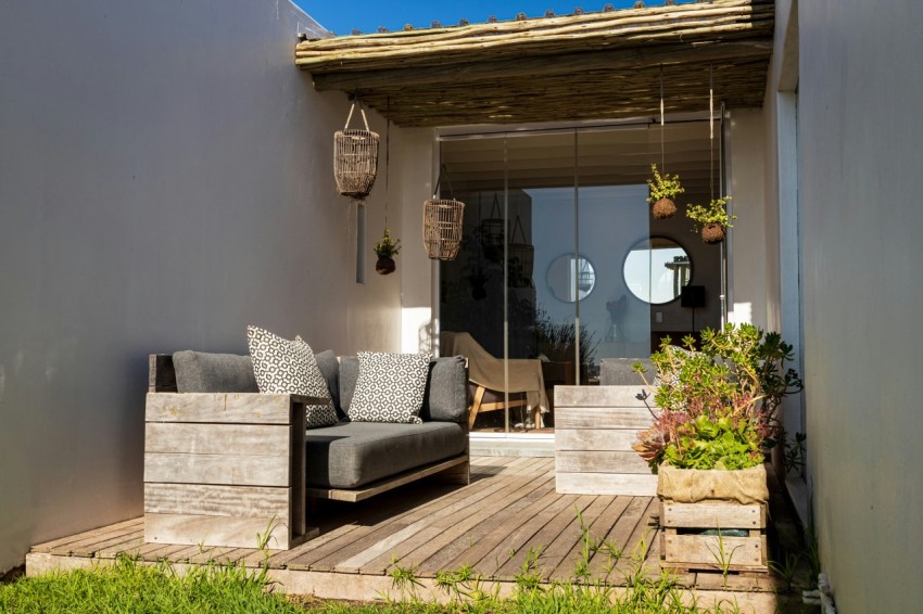 a couch sitting on top of a wooden deck