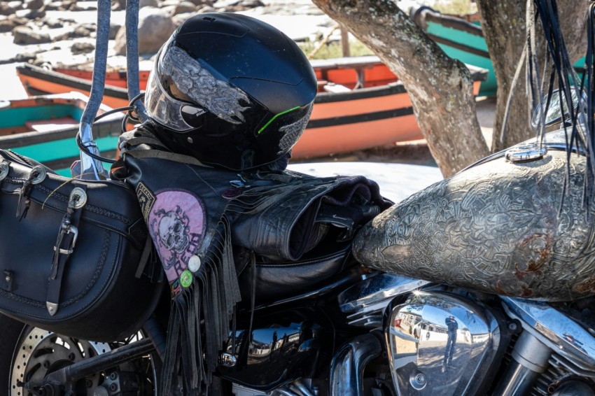 a motorcycle with a helmet and a bag on the back of it