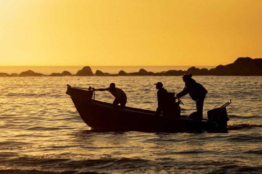 a group of people on a boat in the water