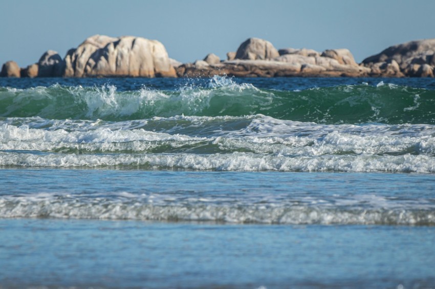 a man riding a surfboard on top of a wave in the ocean