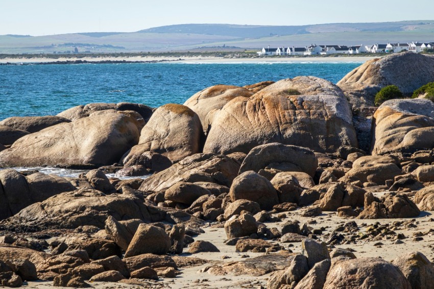 a view of a beach with rocks and a body of water