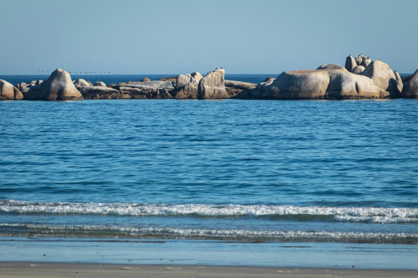 a large body of water sitting next to a sandy beach