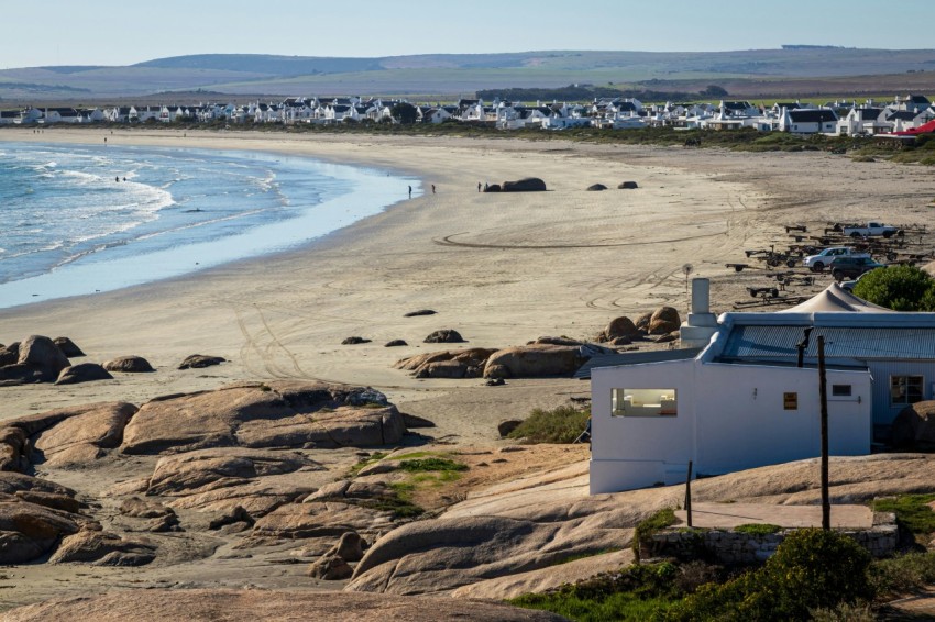 a view of a beach with houses on the shore