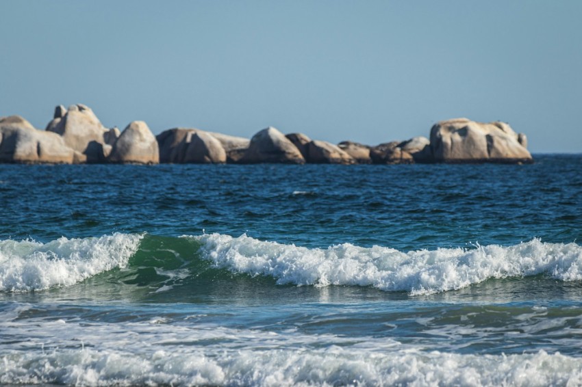 a group of rocks sitting on top of a body of water