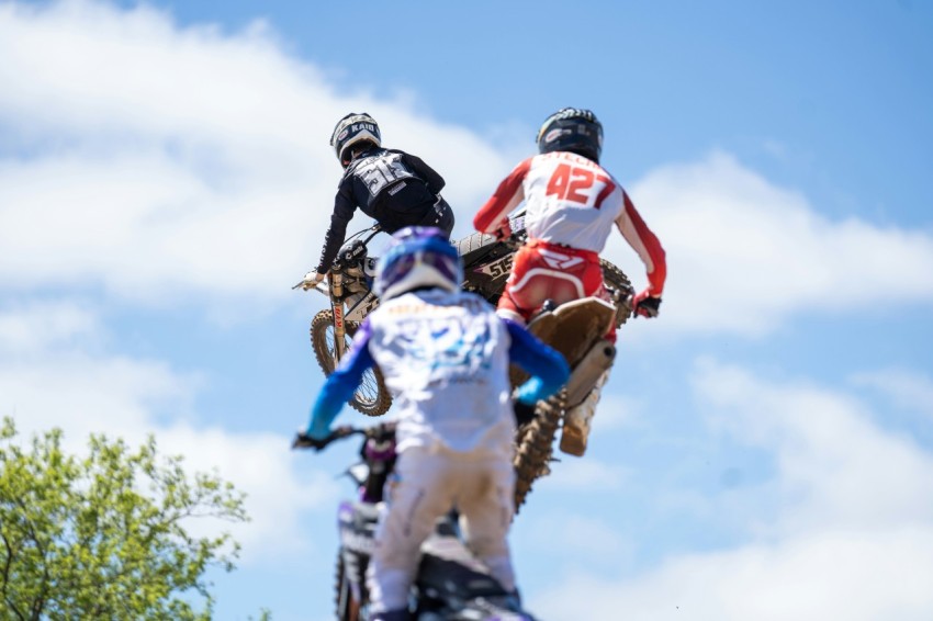 a group of people riding on the back of dirt bikes