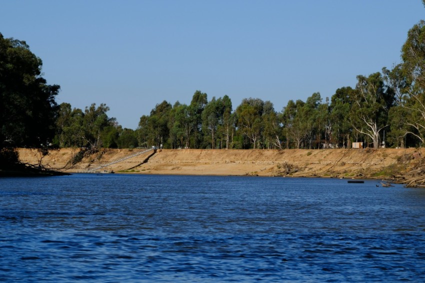 a body of water with trees in the background AenDS