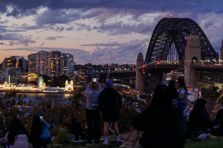 a group of people sitting on top of a hill