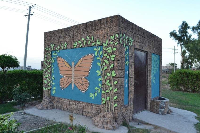 a small building with a butterfly painted on it