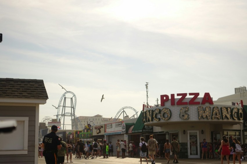 a crowd of people walking around a carnival