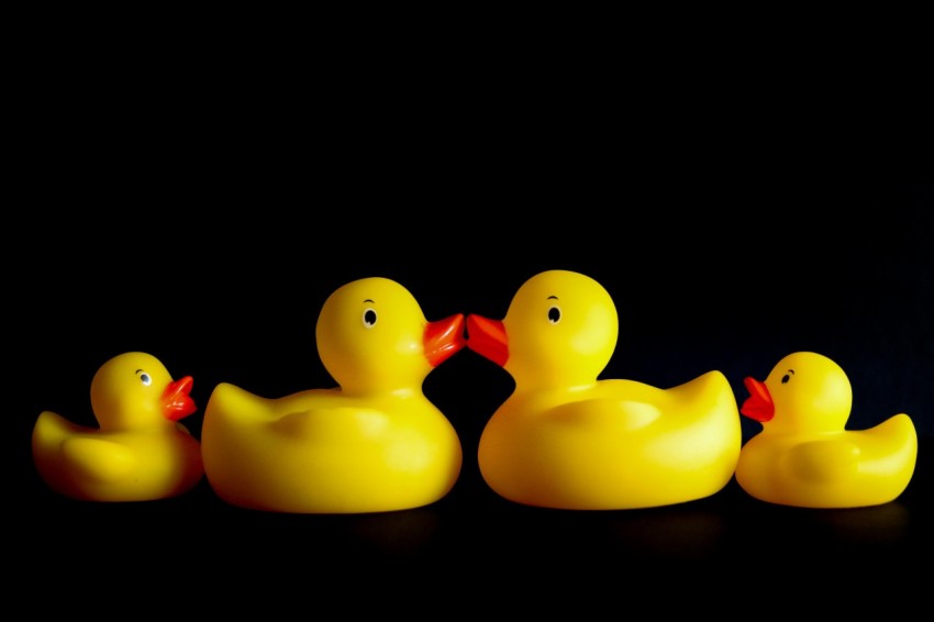 a group of rubber ducks sitting on top of a table