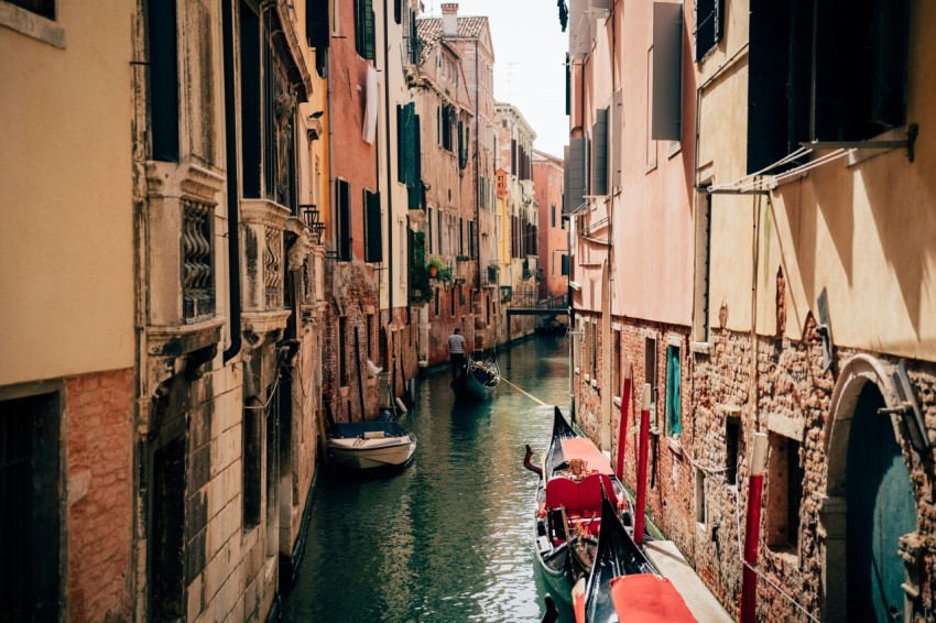 a narrow canal with a few boats in it