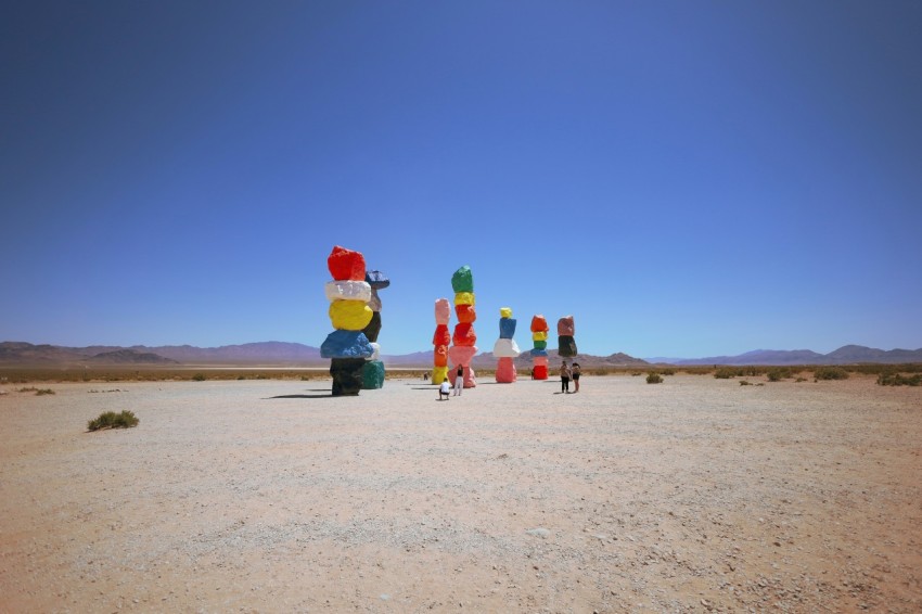 a group of people standing in the middle of a desert