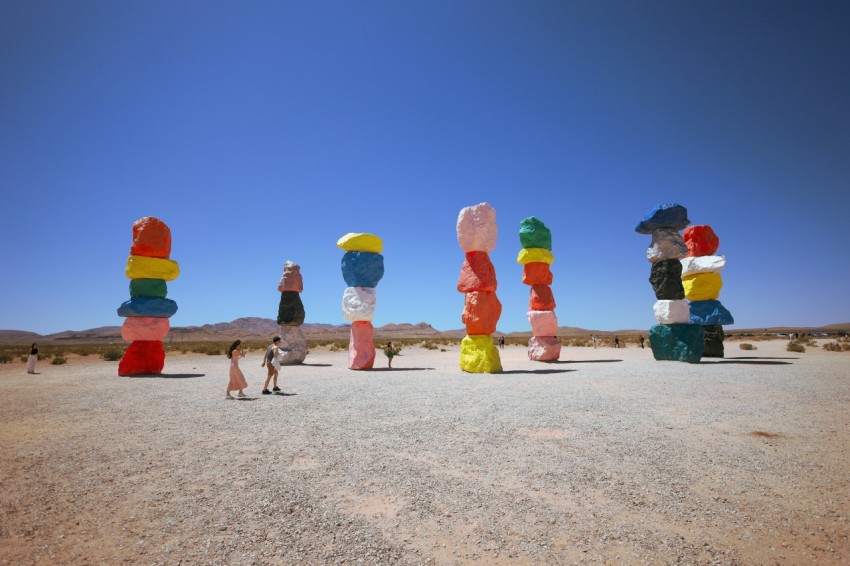 a group of people standing in the middle of a desert