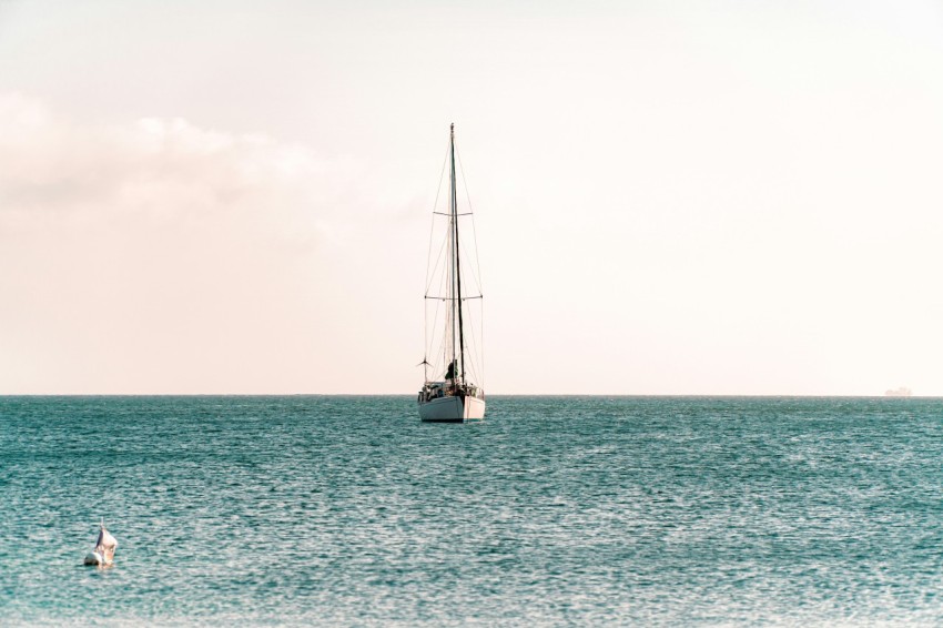 a sailboat floating in the middle of the ocean