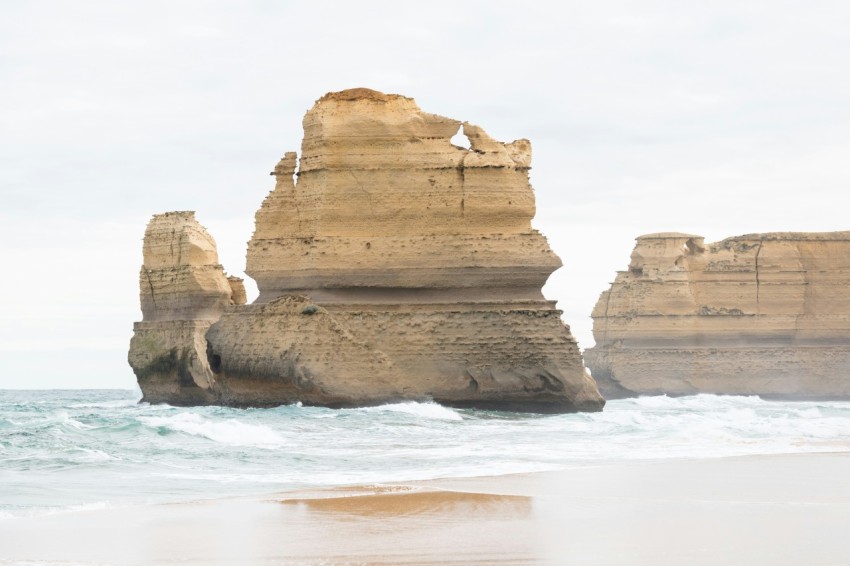 a large rock formation in the middle of the ocean