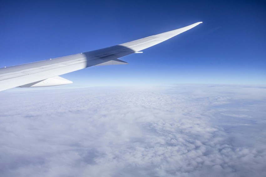 the wing of an airplane flying above the clouds